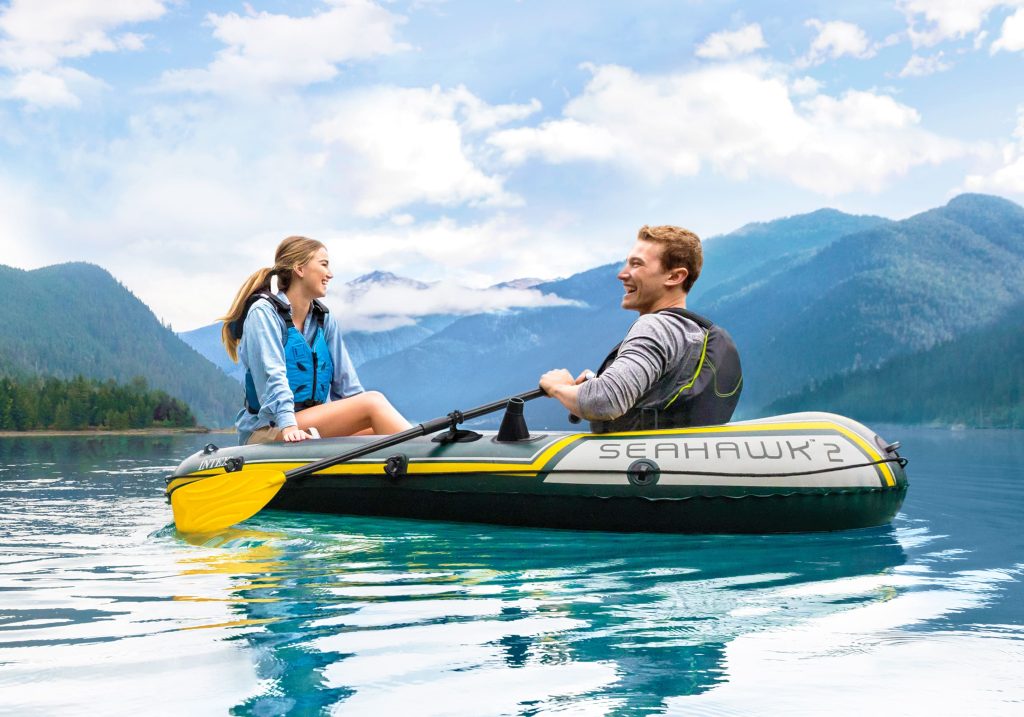 Pareja disfrutando de paseo en barca hinchable INTEX por lago